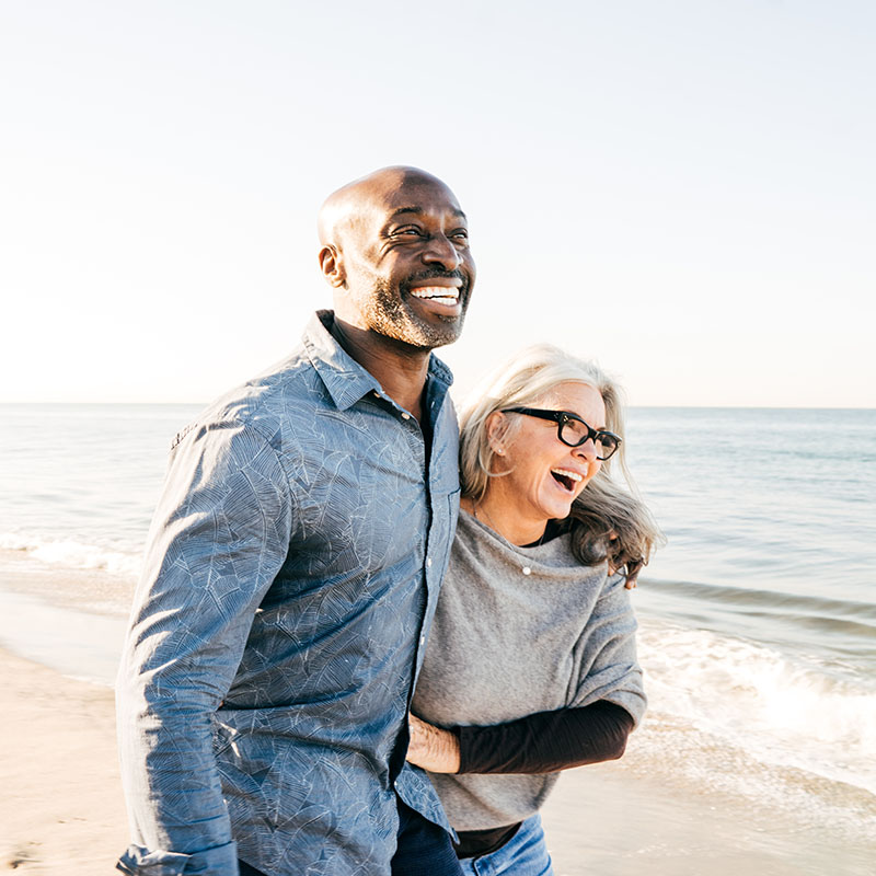 Senior couple walking on the beach