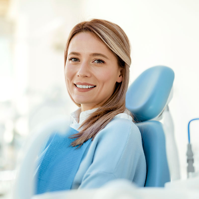 Young woman portrait visiting the dentist and smiling