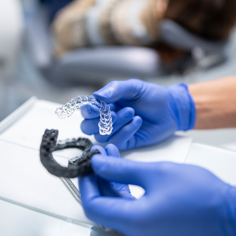 Orthodontist preparing dental aligners for patient